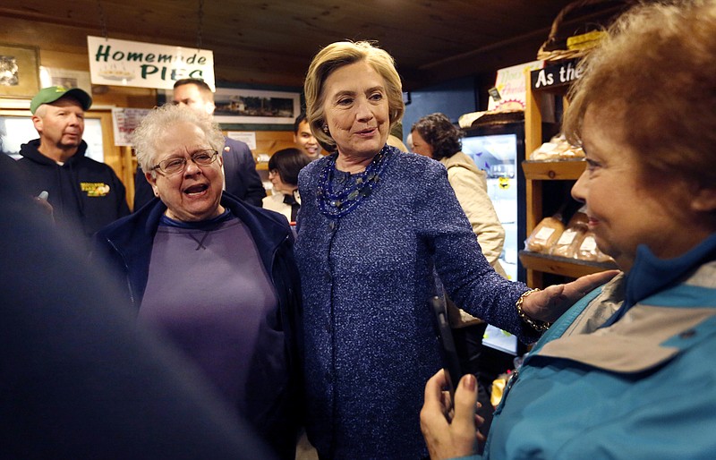 Democratic presidential candidate Hillary Rodham Clinton, center, meets with customers during a campaign stop at the Moulton Farm Wednesday, Oct. 28, 2015, in Meredith, N.H. 