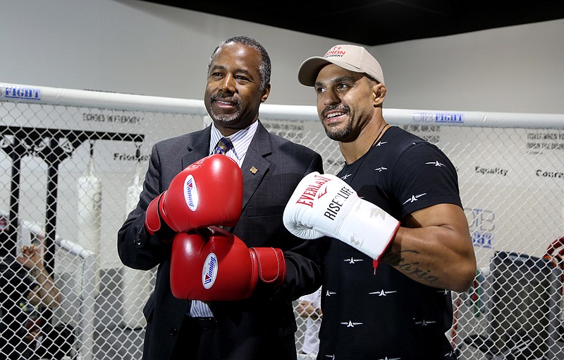 
              UFC middleweight fighter Vitor Belfort poses with presidential candidate Ben Carson at the OTB Fight gym in Coconut Creek, Fla. Belfort is endorsing Carson.  (Susan Stocker/South Florida Sun-Sentinel via AP)  MAGS OUT; MANDATORY CREDIT
            