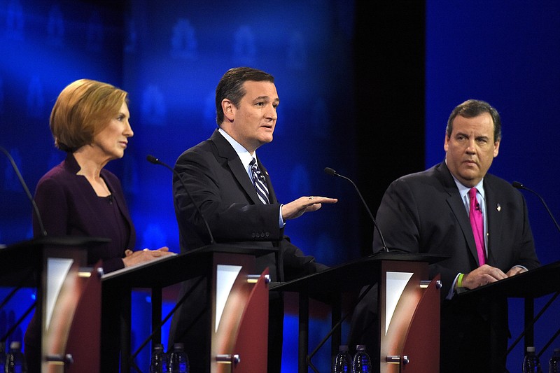 Ted Cruz, center, speaks as Carly Fiorina, left, and Chris Christie listen during the CNBC Republican presidential debate at the University of Colorado, Wednesday, Oct. 28, 2015, in Boulder, Colo.