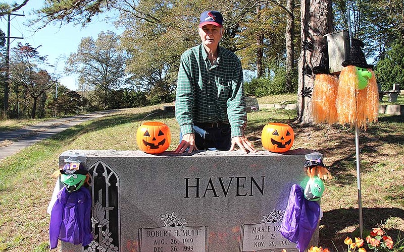 Dick Wolfe, the self-appointed caretaker of Ooltewah Cemetery, stands next to decorations he put up for Halloween on October 21, 2015. 