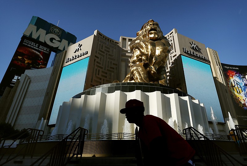 
              FILE - In this Aug. 3, 2015, file photo, a man rides his bike past the MGM Grand hotel and casino in Las Vegas. MGM Resorts International on Thursday, Oct. 29, 2015 announced it plans to spin off part of its casino-resort real estate into a separate company that will lease the properties back to MGM to boost value for shareholders and give both companies more flexibility to grow. (AP Photo/John Locher, File)
            