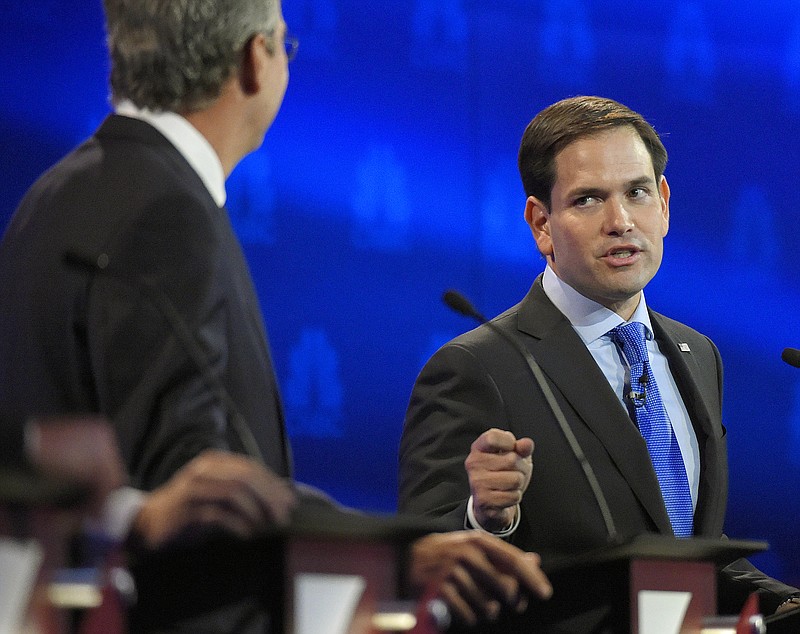 Sen. Marco Rubio, R-Fla., right, responds to a criticism by former Florida Gov. Jeb Bush in Wednesday's CNBC Republican presidential debate in Boulder, Colo.