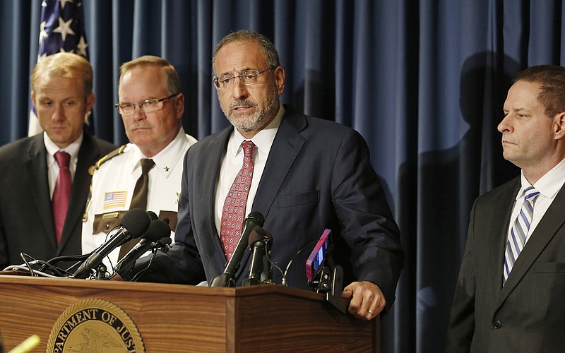 
              U.S. Attorney Andrew Luger, center, addresses a press conference, Thursday, Oct. 29, 2015, in Minneapolis, where federal charges stemming from a long-term child exploitation investigation were announced against Daniel Heinrich. The FBI says Heinrich is a person of interest in the 1989 abduction of Jacob Wetterling. Others, from left: BCA Superintendent Drew Evans, Stearns County Sheriff John Sanner, and FBI Special Agent in Charge Richard Thornton, right. (AP Photo/Jim Mone)
            