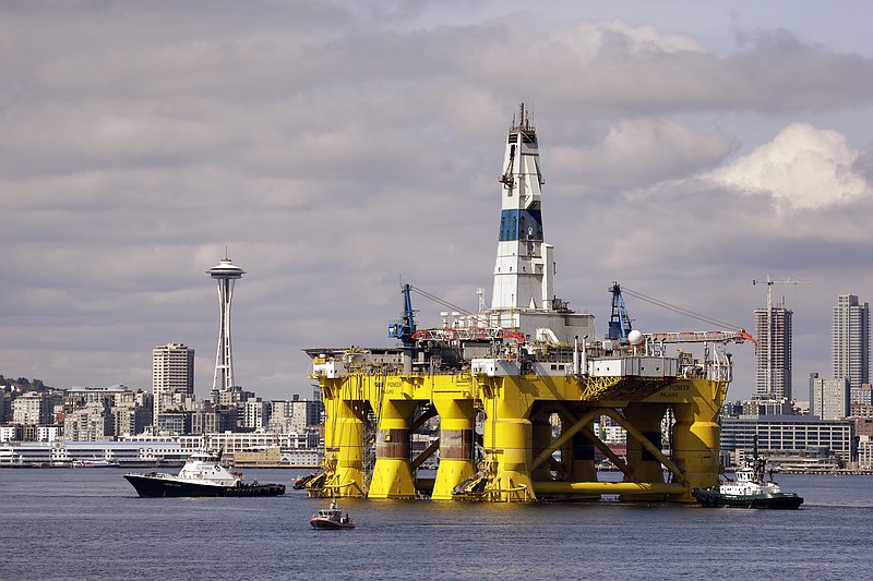 
              FILE - In this Thursday, May 14, 2015 file photo, the Royal Dutch Shell oil drilling rig Polar Pioneer is towed toward a dock in Elliott Bay in Seattle. Royal Dutch Shell reported a third quarter loss of $7.4 billion Thursday, Oct, 29, 2015 as it re-organized and canceled projects, including drilling in Alaska, to cope with the plunge in oil prices. The net loss compares with a profit of $4.5 billion in the same period last year. Shell reported $7.9 billion in charges, including $2.6 billion for Alaska and $2 billion related to the decision to cancel the Carmon Creek project in Alberta, Canada. Excluding one-time items and fluctuations in the value of inventories, the company said profit dropped to $1.8 billion, from $5.8 billion a year earlier, reflecting the plunge in oil prices.  (AP Photo/Elaine Thompson, File)
            