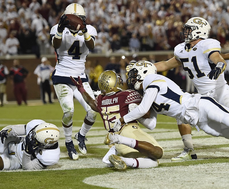 Georgia Tech defensive back Jamal Golden (4) picks off a ball from Florida State wide receiver Travis Rudolph (15) during the second half of an NCAA college football game, Saturday, Oct. 24, 2015, in Atlanta. Georgia Tech won 22-16.