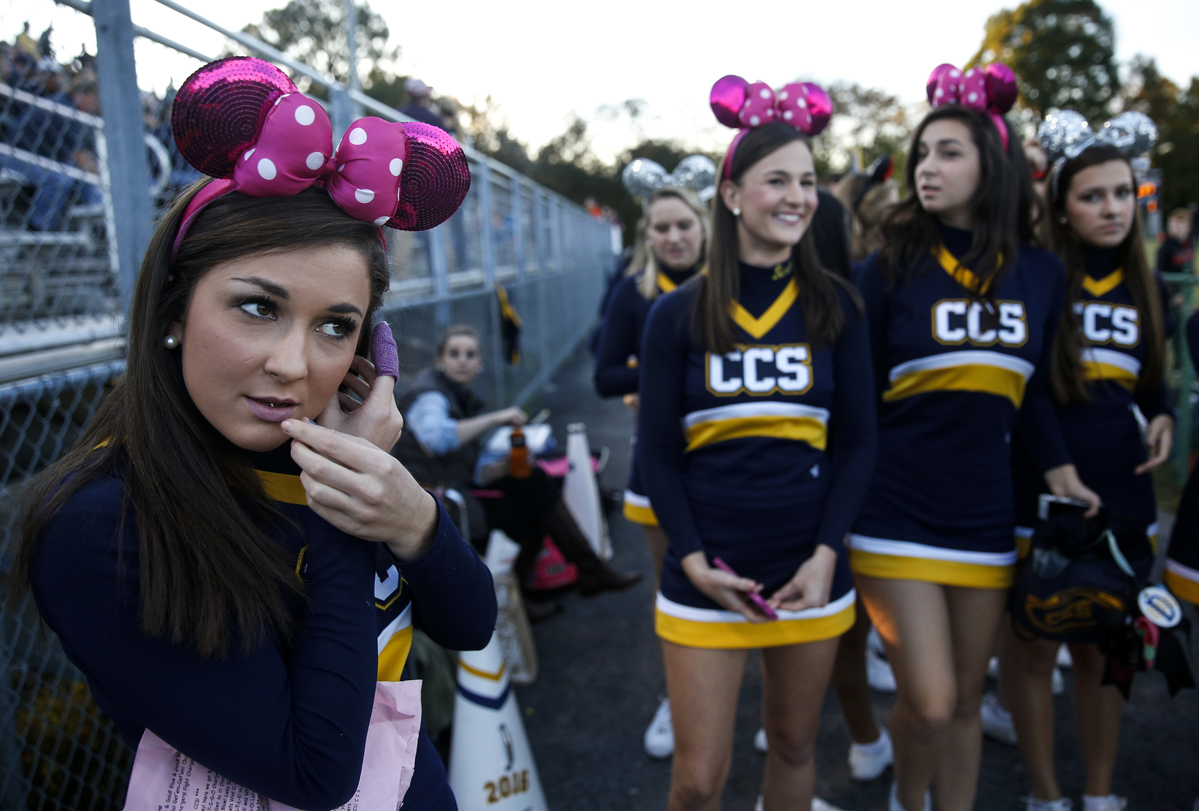 CCS cheerleader Mary Leeanna Garrett, left, fixes her hair with her teammates before their prep football game against East Ridge at East Ridge High School on Friday, Oct. 30, 2015, in East Ridge, Tenn.