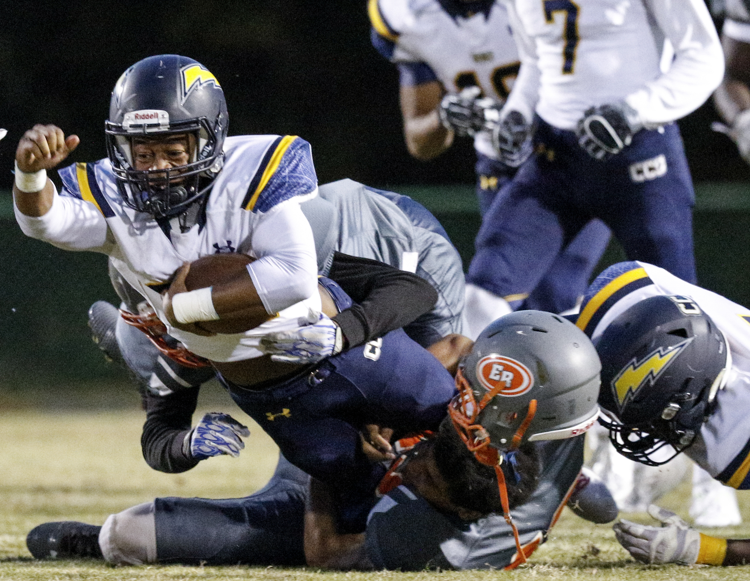 CCS running back T.J. Smith, left, struggles for extra yardage as he's tackled by East Ridge's Braxton Moffett during their prep football game at East Ridge High School on Friday, Oct. 30, 2015, in East Ridge, Tenn.
