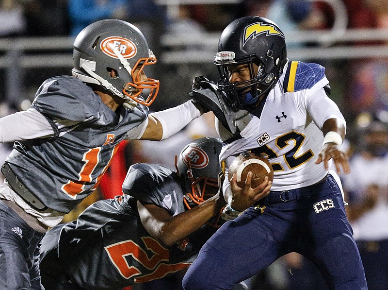 CCS running back T.J. Smith, right, pushes into East Ridge defenders Jordan Harvey, left, and B.J. Church during their prep football game at East Ridge High School on Friday, Oct. 30, 2015, in East Ridge, Tenn.