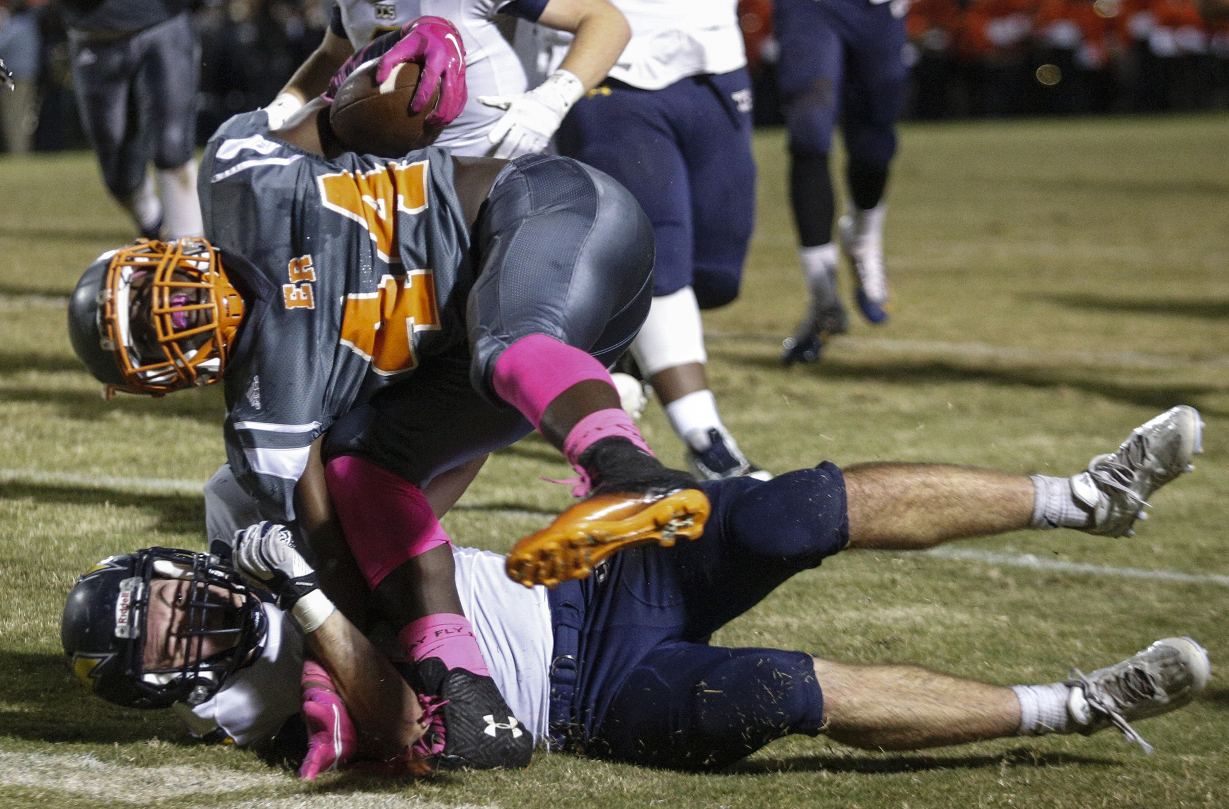 East Ridge running back Lorenzo Stewart, top, is upended by CCS defender Nick Fulmer during their prep football game at East Ridge High School on Friday, Oct. 30, 2015, in East Ridge, Tenn.