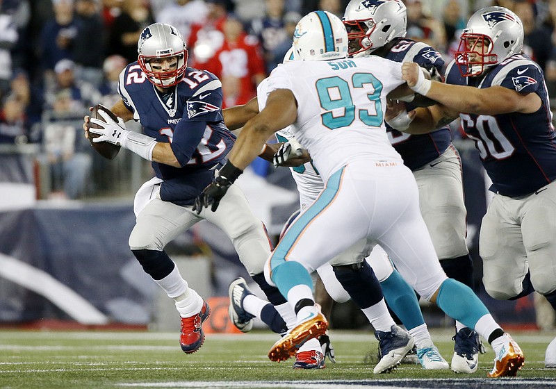 
              New England Patriots quarterback Tom Brady (12) scrambles away from Miami Dolphins defensive tackle Ndamukong Suh (93) in the first half of an NFL football game, Thursday, Oct. 29, 2015, in Foxborough, Mass. (AP Photo/Michael Dwyer)
            