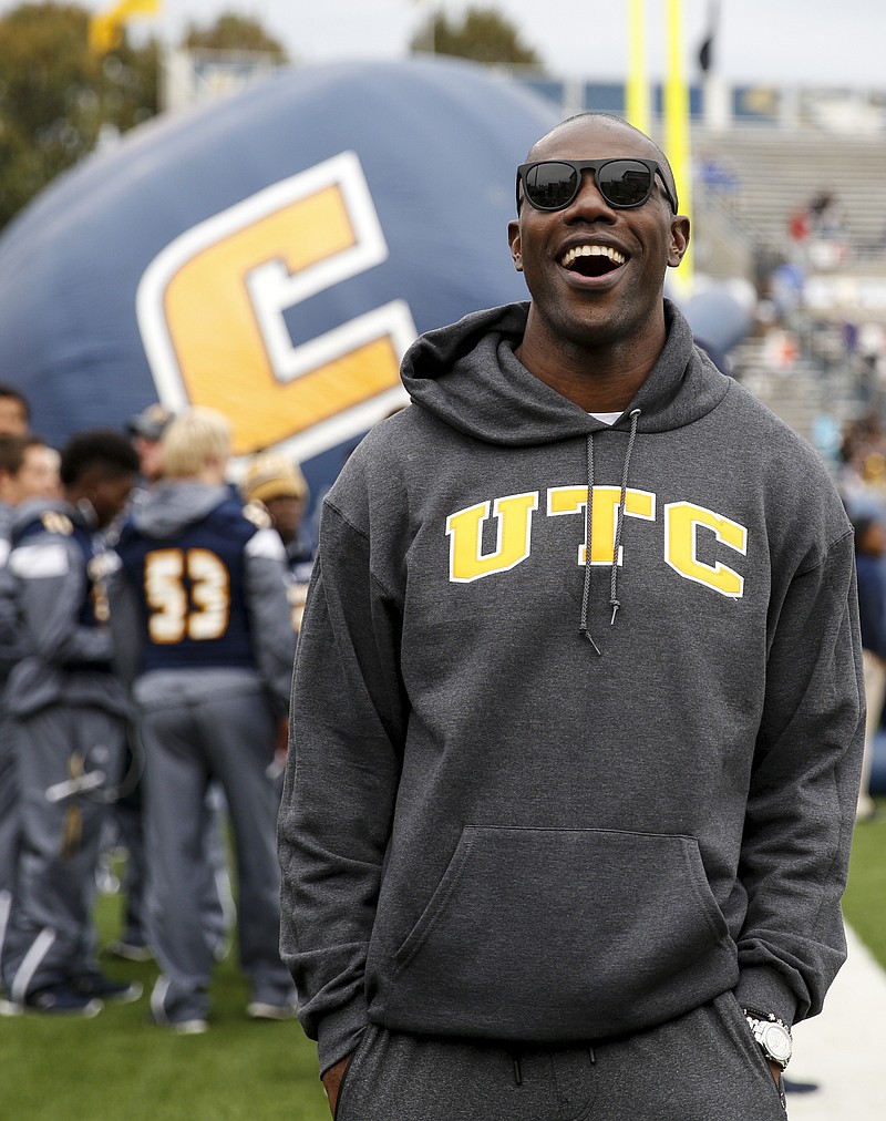 Former UTC standout player Terrell Owens laughs on the sidelines of the Mocs' SoCon football game against Western Carolina at Finley Stadium on Saturday, Oct. 31, 2015, in Chattanooga, Tenn.