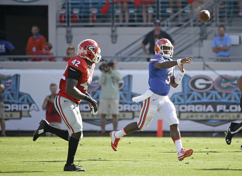 Florida quarterback Treon Harris (3) throws a pass past Georgia linebacker Tim Kimbrough (42) during the first half of an NCAA college football game Saturday, Oct. 31, 2015, in Jacksonville, Fla.