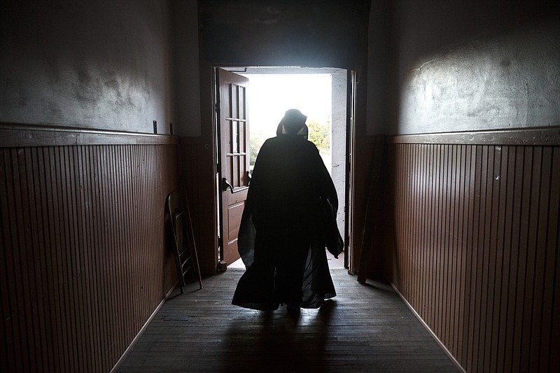 Pastor Chris Hagler walks outside for a rehearsal for the Rising Fawn Church of God's Hell House event at South Dade Community Center on Thursday, Oct. 29, 2015, in Rising Fawn, Ga. The annual event takes visitors through scenes of sinning actors before arriving in a simulated hell, and it concludes with a scene of heaven.