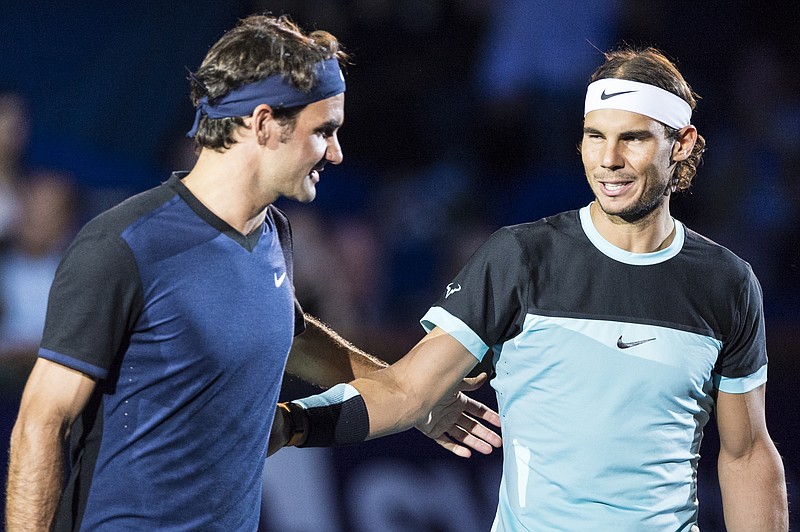 
              Switzerland's Roger Federer, left, and Spain's Rafael Nadal, right, share a word before their final match at the Swiss Indoors tennis tournament at the St. Jakobshalle in Basel, Switzerland, Sunday, Nov. 1, 2015. (Dominic Steinmann/Keystone via AP)
            