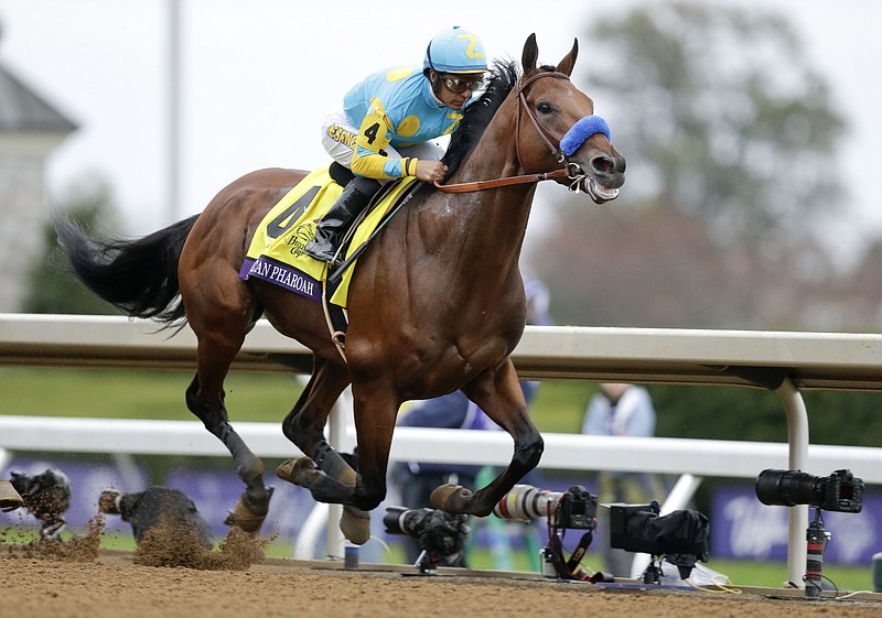 
              American Pharoah, with Victor Espinoza up, wins the Breeders' Cup Classic horse race at Keeneland race track Saturday, Oct. 31, 2015, in Lexington, Ky. (AP Photo/Garry Jones)
            