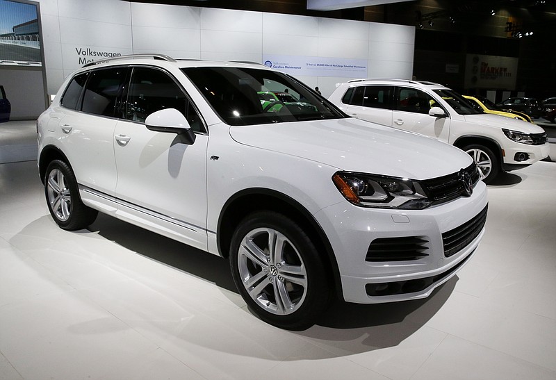 FILE - In this Feb. 7, 2014 file photo, the 2014 Volkswagen Touareg TDI R-Line is on display during the media preview of the Chicago Auto Show at McCormick Place in Chicago. The U.S. government says Volkswagen cheated a second time on emissions tests, programming about 10,000 cars with larger diesel engines, including the 2014 Touareg, 2015 Porsche Cayenne and the 2016 Audi A6 Quattro, A7 Quattro, A8 and Q5, to emit fewer pollutants during testing than in real-world driving conditions. (AP photo/Nam Y. Huh, File)