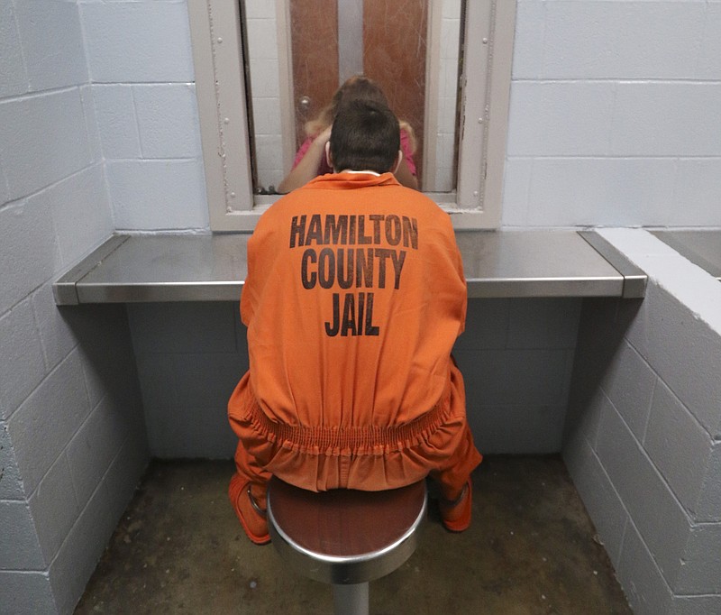 An inmate and his visitor converse during a scheduled visitation at the Hamilton County Jail in downtown Chattanooga on Aug. 5.