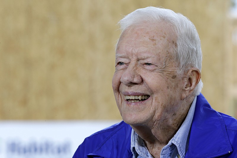 In this Nov. 1, 2015 photo, former President Jimmy Carter is interviewed at a Habitat for Humanity project site in Memphis, Tenn. Carter said it's too soon to tell whether treatment he received for his brain cancer has been effective, but that he hasn't been uncomfortable or ill while receiving rounds of immune-boosting drugs. 