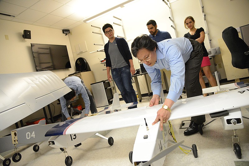 Daniel Pack works with a fixed-wing drone in his lab.