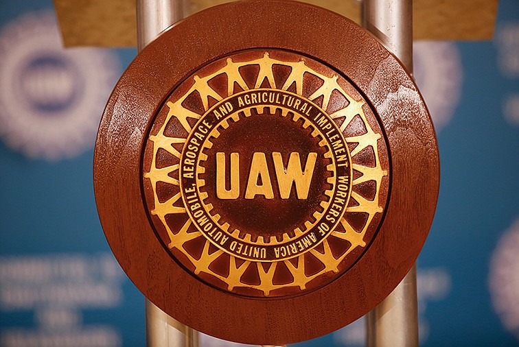 The UAW logo is displayed on the podium at a news conference in July.