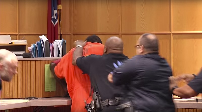 Hamilton County Court officers restrain Antwon Lee as he attacks Eric McCullough (obscured) in Judge Gary Starnes courtroom.  McCullough is accused of killing his niece who was Lee's girlfriend.  