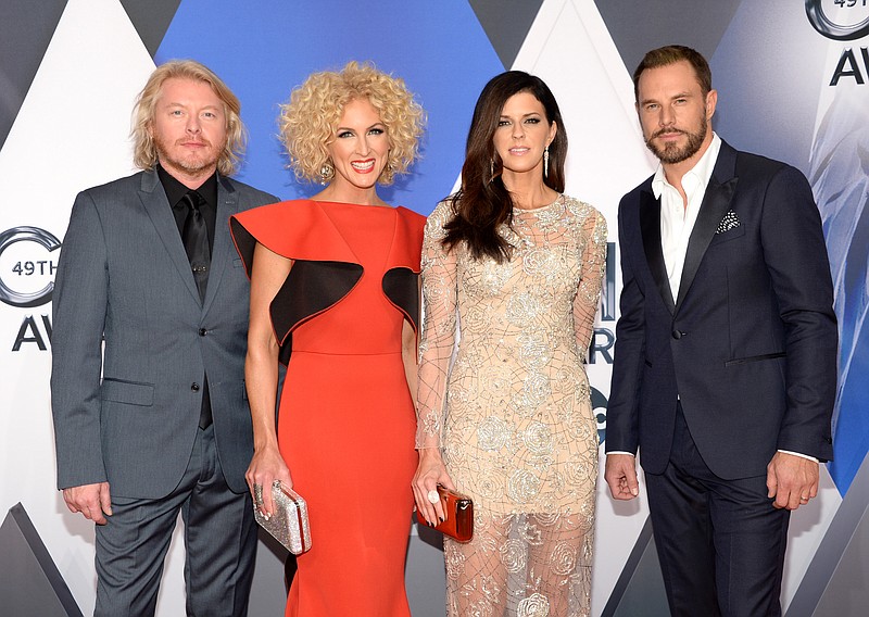 
              Phillip Sweet, from left, Kimberly Schlapman, Karen Fairchild and Jimi Westbrook, of Little Big Town, arrive at the 49th annual CMA Awards at the Bridgestone Arena on Wednesday, Nov. 4, 2015, in Nashville, Tenn. (Photo by Evan Agostini/Invision/AP)
            