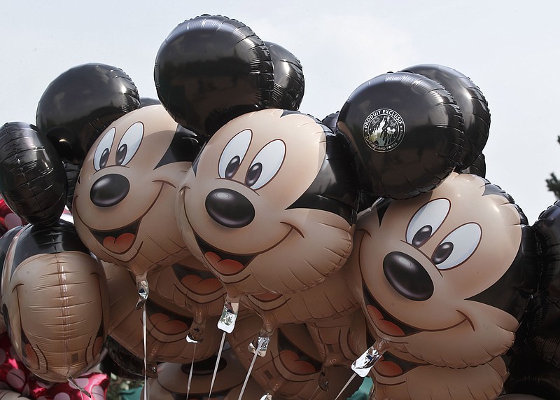 
              FILE - This May 12, 2015 file photo shows Mickey Mouse balloons at Disneyland Paris, in Chessy, France, east of Paris. Disney is allaying concerns about cord-cutting after reporting better-than-expected revenue in the cable-network division that houses ESPN. Disney said Thursday, Nov. 5, 2015, that revenue at its leading business, cable networks, rose 12 percent to $4.25 billion in the fiscal fourth quarter, beating the $4.22 billion expected by analysts polled by FactSet.  (AP Photo/Michel Euler, File)
            