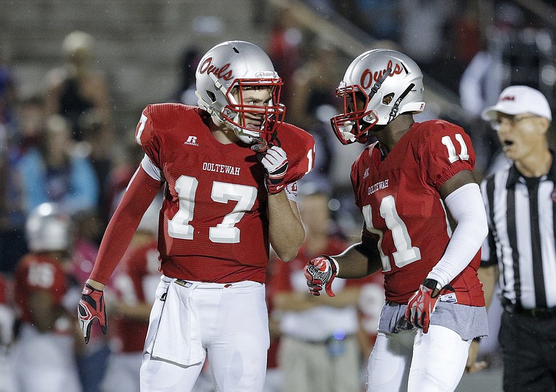 Ooltewah quarterback London Elrod, left, talks with Rashun Freeman before a play during their prep football game at Ooltewah High School on Friday, Sept. 11, 2015, in Ooltewah, Tenn.