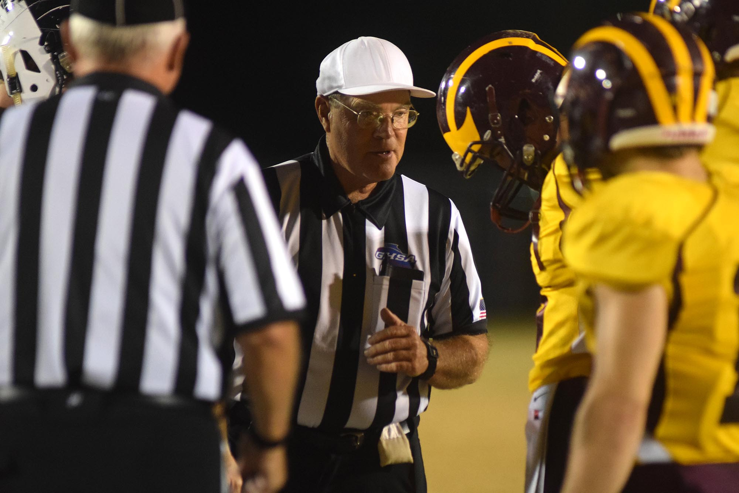 The referee directs the team captains before the coin toss.  The Gordon Lee Trojans visited the Dade County Wolverines in GHSA football action Thursday night, November 5, 2015.