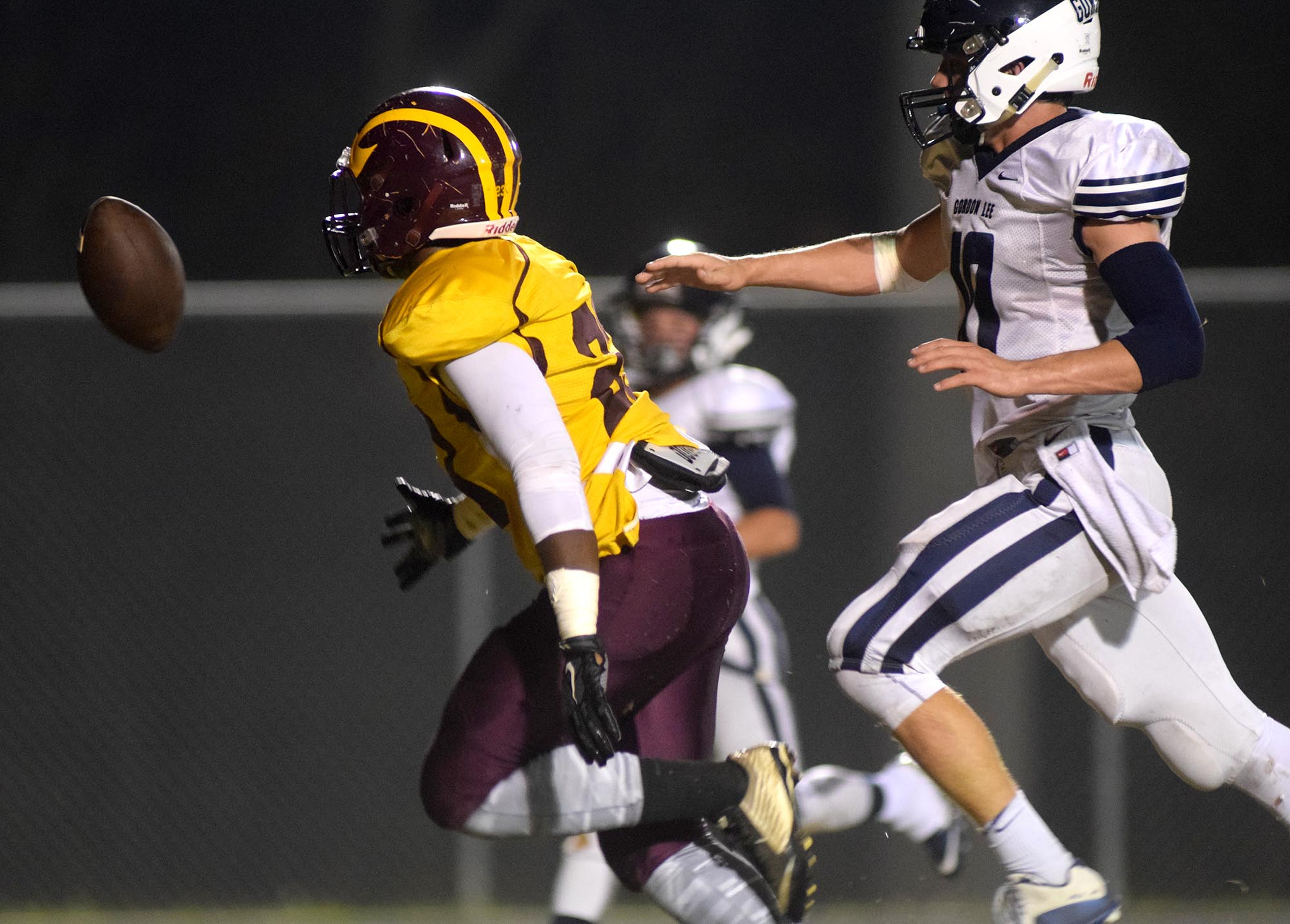 The ball is just of the reach of Dade County's Kam Jones (23) as Gordon Lee's Caleb O'Neal (10) defends.  The Gordon Lee Trojans visited the Dade County Wolverines in GHSA football action Thursday night, November 5, 2015.