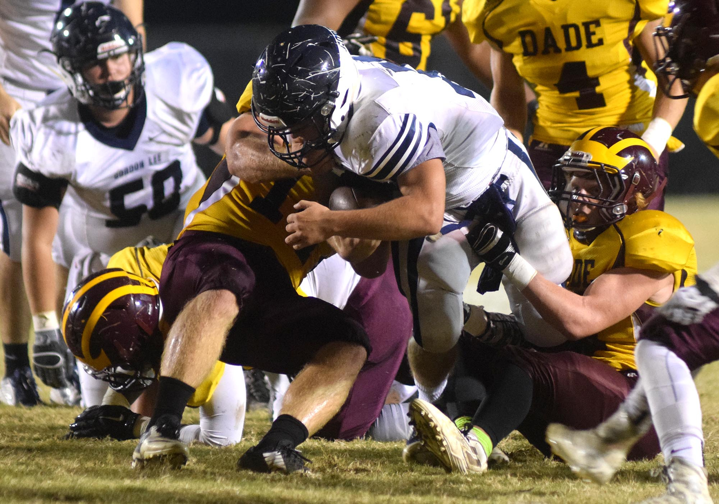 Gordon Lee's Andrew Towns (35) is dragged down by the Dade County defense after getting a Trojan first down.  The Gordon Lee Trojans visited the Dade County Wolverines in GHSA football action Thursday night, November 5, 2015.