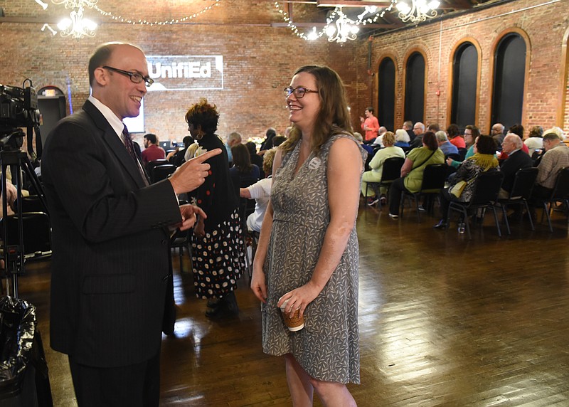 Richard Kahlenberg, left, talks with Elizabeth Crews, executive director of the local nonprofit UnifiEd, as the Church on Main fills with attendees Thursday. Kahlenberg spoke about reducing separate and unequal schooling in Hamilton County.