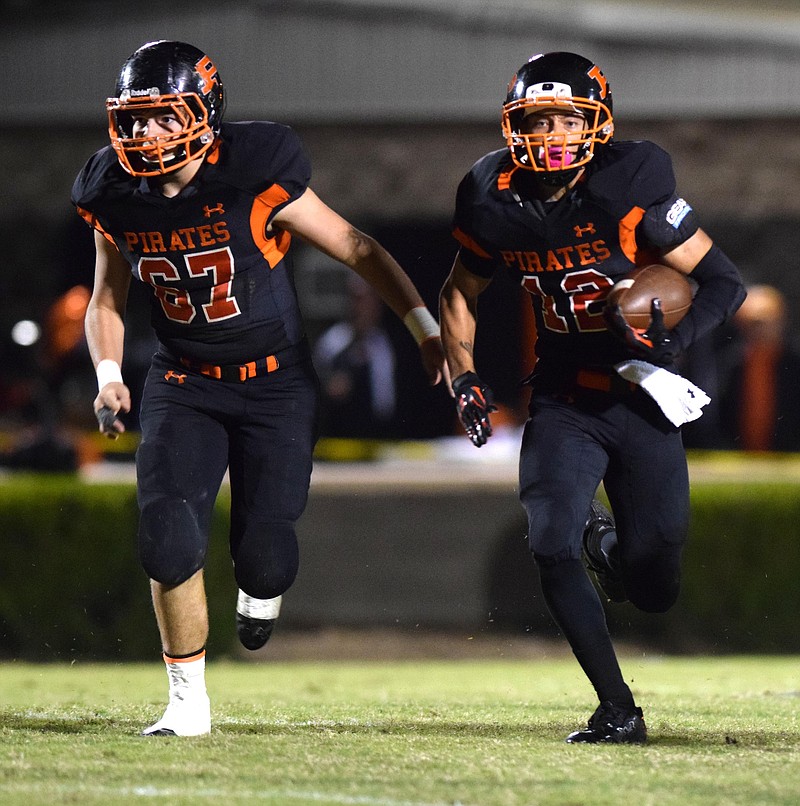 South Pittsburg's Joseph Lilly (12) follows the block of Hayden Branham (67).  Lilly scored a touchdown on the play.  Grace Baptist Academy visited South Pittsburg in aTSSAA football game on Friday, October 16, 2015.