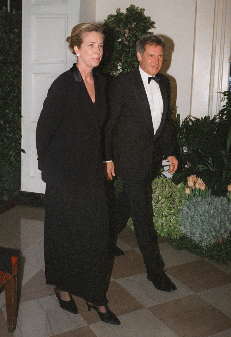 
              FILE - In this Feb. 5, 1998 file photo, Harrison Ford and his wife Melissa Mathison arrive at the White House for an official dinner for the British Prime Minister hosted by President Clinton in Washington. Mathison, the screenwriter who crafted the enchanting worlds of iconic family films including "E.T. the Extra Terrestrial," has died. She passed away Wednesday, Nov. 4, 2015, at age 65 after a bout with neuroendocrine cancer, her sister, Melinda Mathison Johnson, confirmed.  Mathison was married to Harrison Ford for 21 years and divorced in 2004. (AP Photo/Neshan H. Naltchayan, File)
            