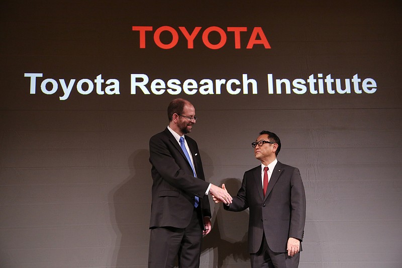 
              Toyota Motor Corp.'s Executive Technical Advisor Gill Pratt, left, and President Akio Toyoda, right, shake hands during  a press conference on artificial intelligence in Tokyo, Friday, Nov. 6, 2015. Toyota is investing $1 billion in a research company it's setting up in Silicon Valley to develop artificial intelligence and robotics, underlining the Japanese automaker's determination to lead in futuristic cars that drive themselves and apply the technology to other areas of daily life. (AP Photo/Eugene Hoshiko)
            