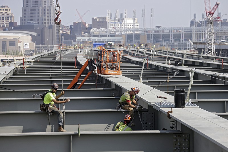 
              In this photo taken Aug. 30, 2013, ironworkers secure a cross member on a highway bridge under construction in Cleveland. The House has voted to continue transportation programs for six years with no significant increase in spending. That’s despite warnings that the nation’s roads, bridges and transit systems are falling apart.  (AP Photo/Mark Duncan)
            