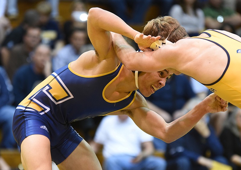 Chris DeBien, left, looks for an advantage against Alex Ward during the Blue vs. Gold UTC wrestling exhibition Oct. 29 at Maclellan Gym. DeBien is one of at least three true freshman in the starting lineup for today's match against Stanford.