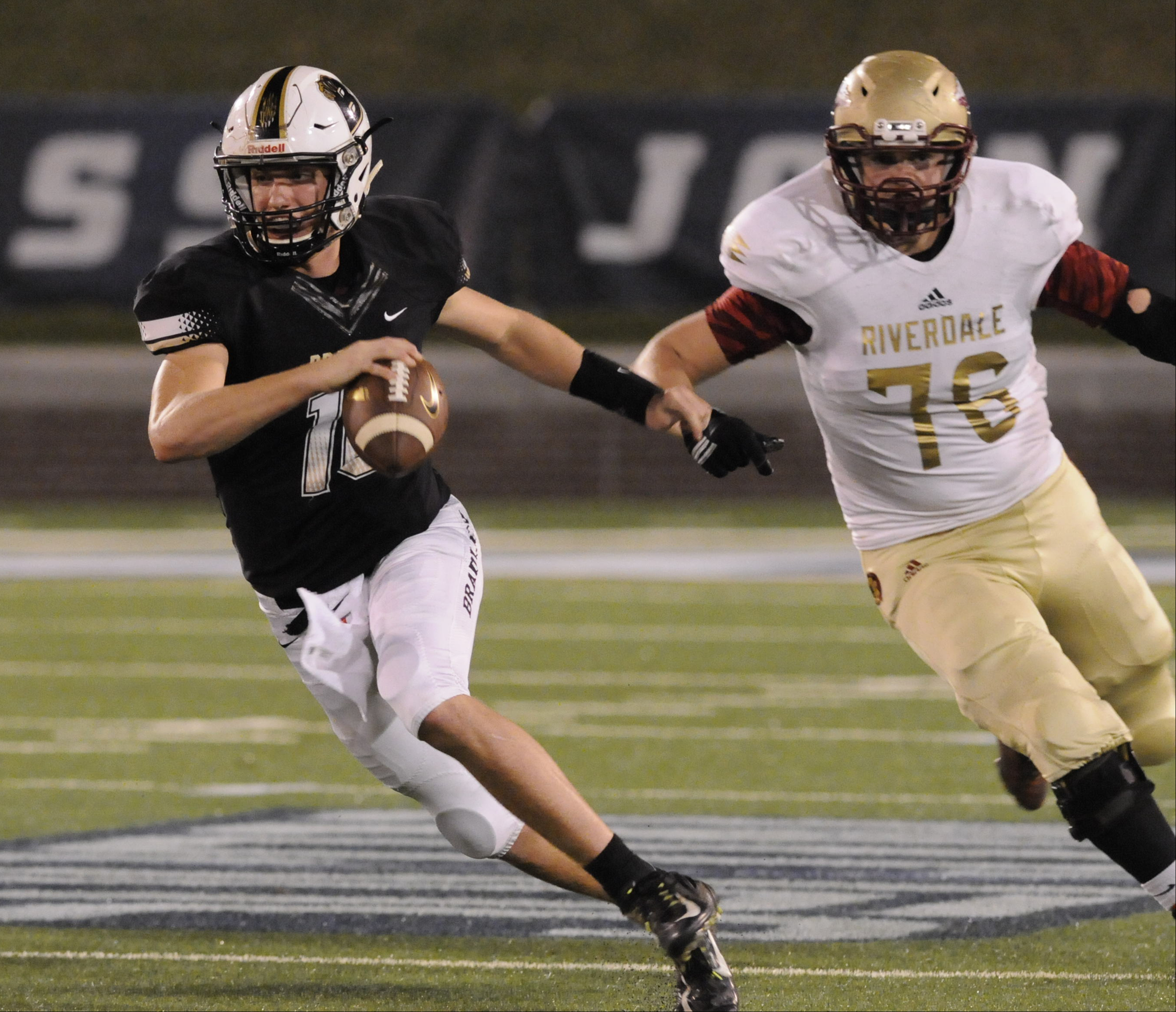 Bradley Central quarterback Cole Copeland escapes Riverdale's Seth Black (76) and runs for short yardageat Finley Stadium Thursday night.