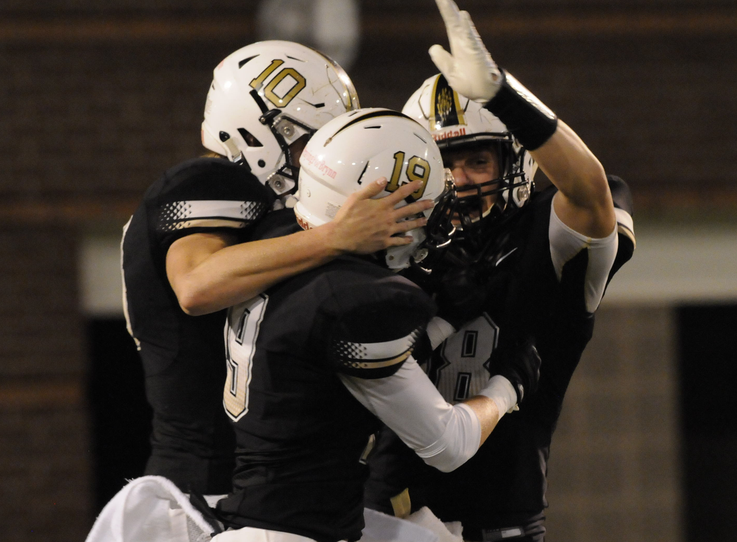 Bradley Central's Cole Copeland, left, Steven Mahonan and Tyler Carpenter (18) celebrate Copeland's first half touchdown run Thursday at Finley Stadium.