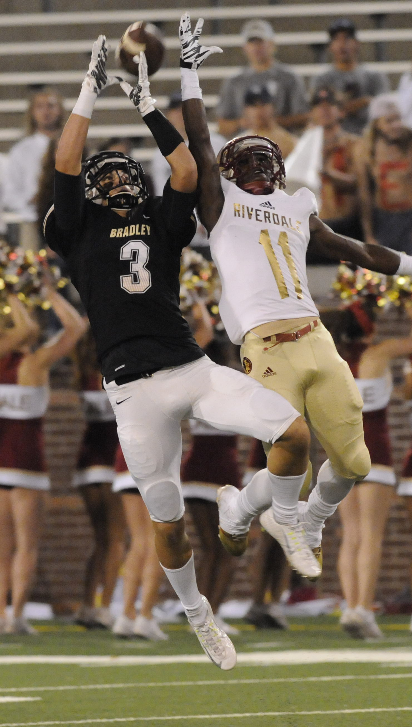 Bradley Central's Nick Howell (3) reaches for a high pass alongside Riverdale defender Marqwell Odom (11) in first half action at Finley Stadium Thursday night.