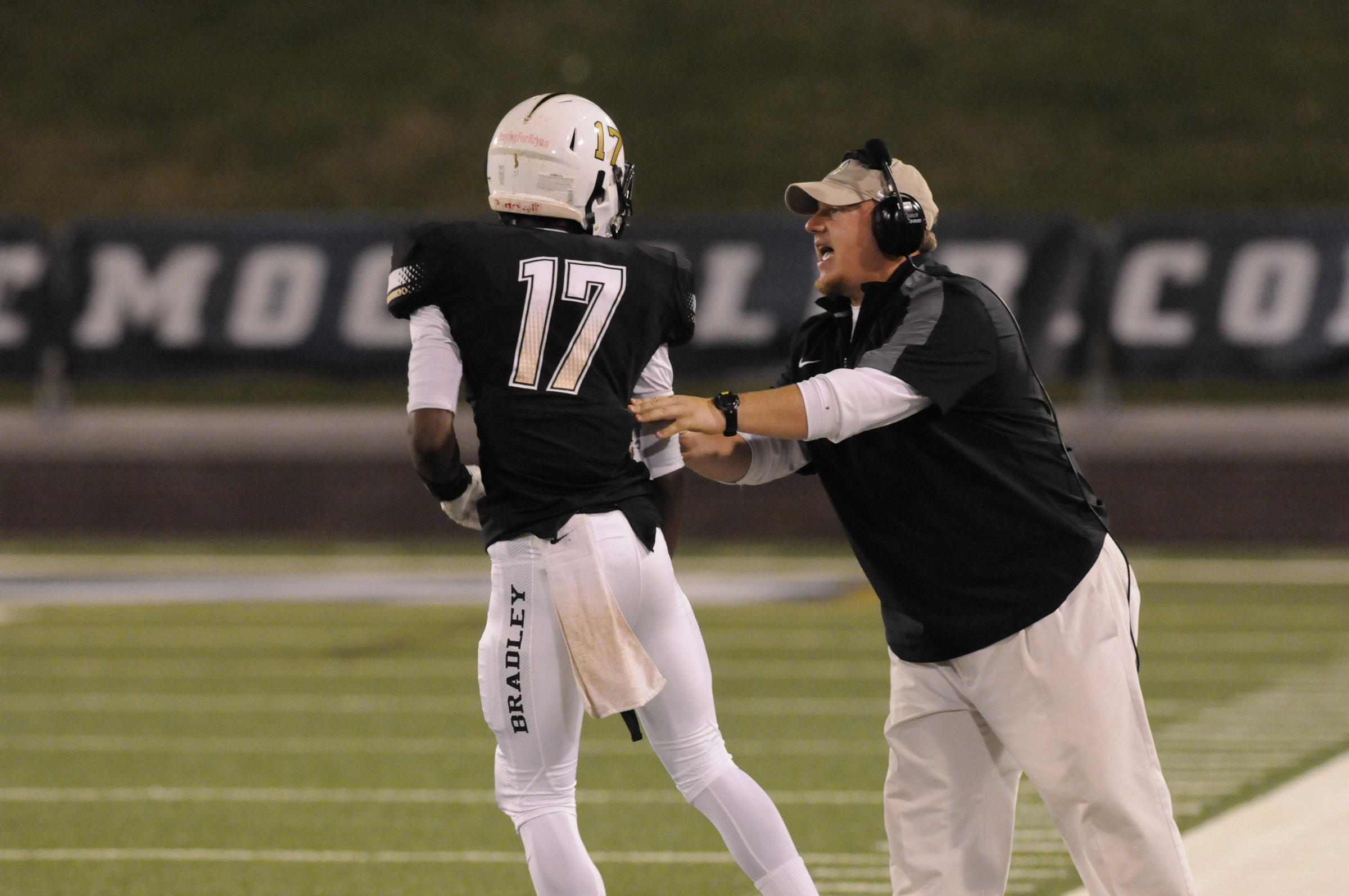 Bradley Central's Ezrick Whaley (17) gets instruction from coach Matt Moody in first half action against Riverdale Thursday night  at Finley Stadium.