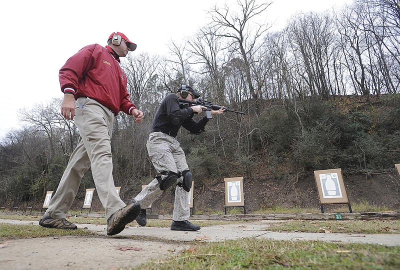 Instructor Gregg Carson walks with Marty Dunn as he practices shooting targets at the Moccasin Bend firing range. City and law enforcement officials are searching for a location for a new range because it is located adjacent to the Moccasin Bend National Archaeological District. The Chattanooga Police Department and Hamilton County Sheriff's Office have used the range for the decades.