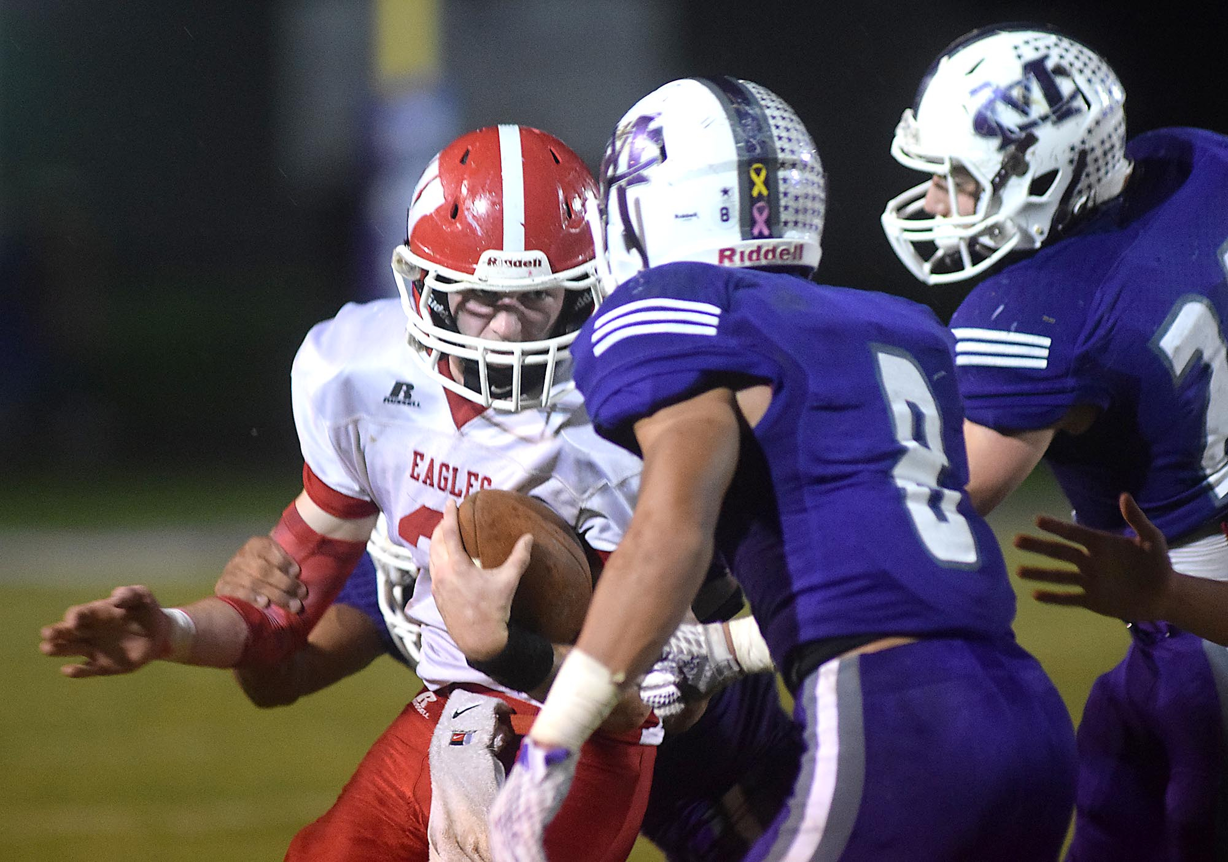 Marion County's Jacob Saylors (8) and Josh Henderson (21) surround Westmoreland quarterback Bayle Kirk (2).  The Westmoreland Eagles visited the Marion County Warriors in the first round of the TSSAA football playoffs Friday night, November 6, 2015.