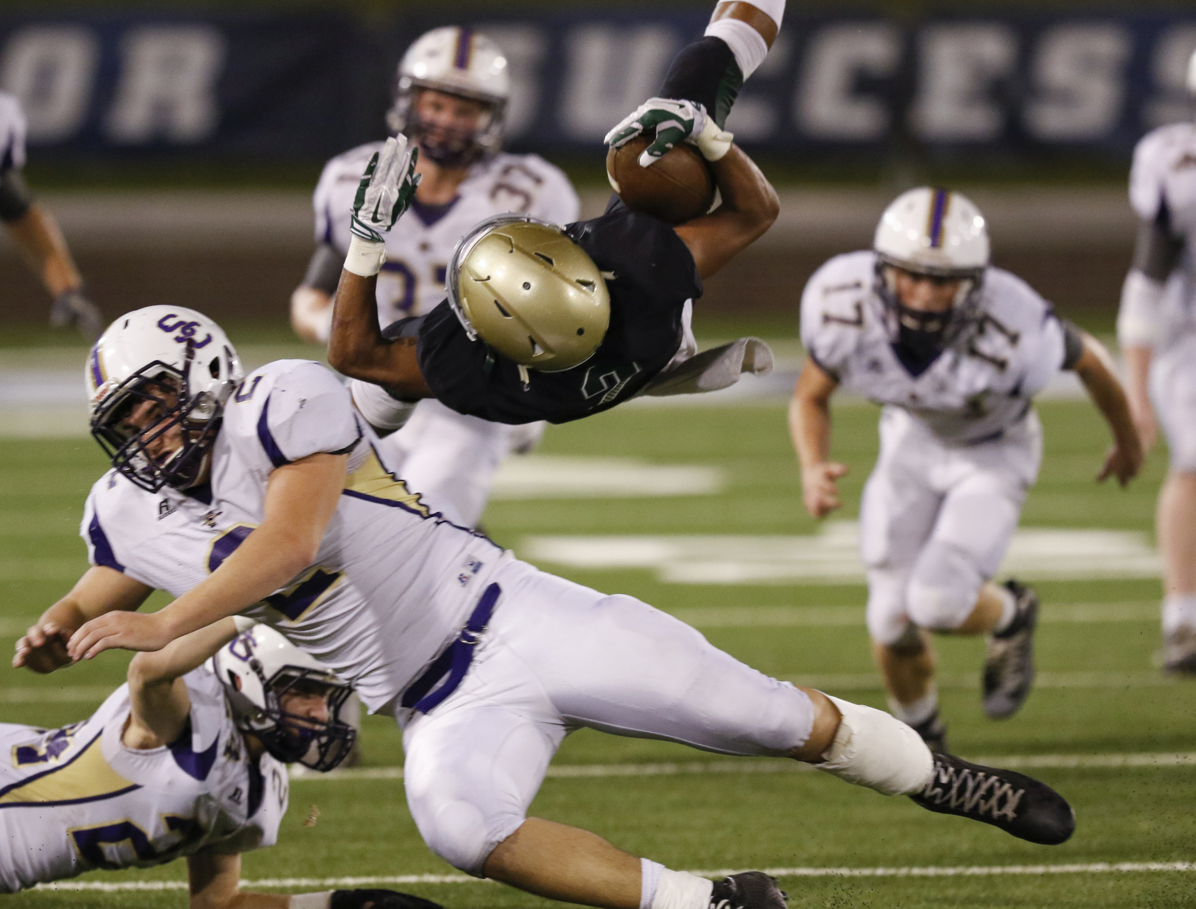 Notre Dame High School's Andrew Banks (2) gets cartwheeled after being hit by Sequatchie County's Kyle Cates (2) during the first half of play at Finley Stadium in downtown Chattanooga on Friday.