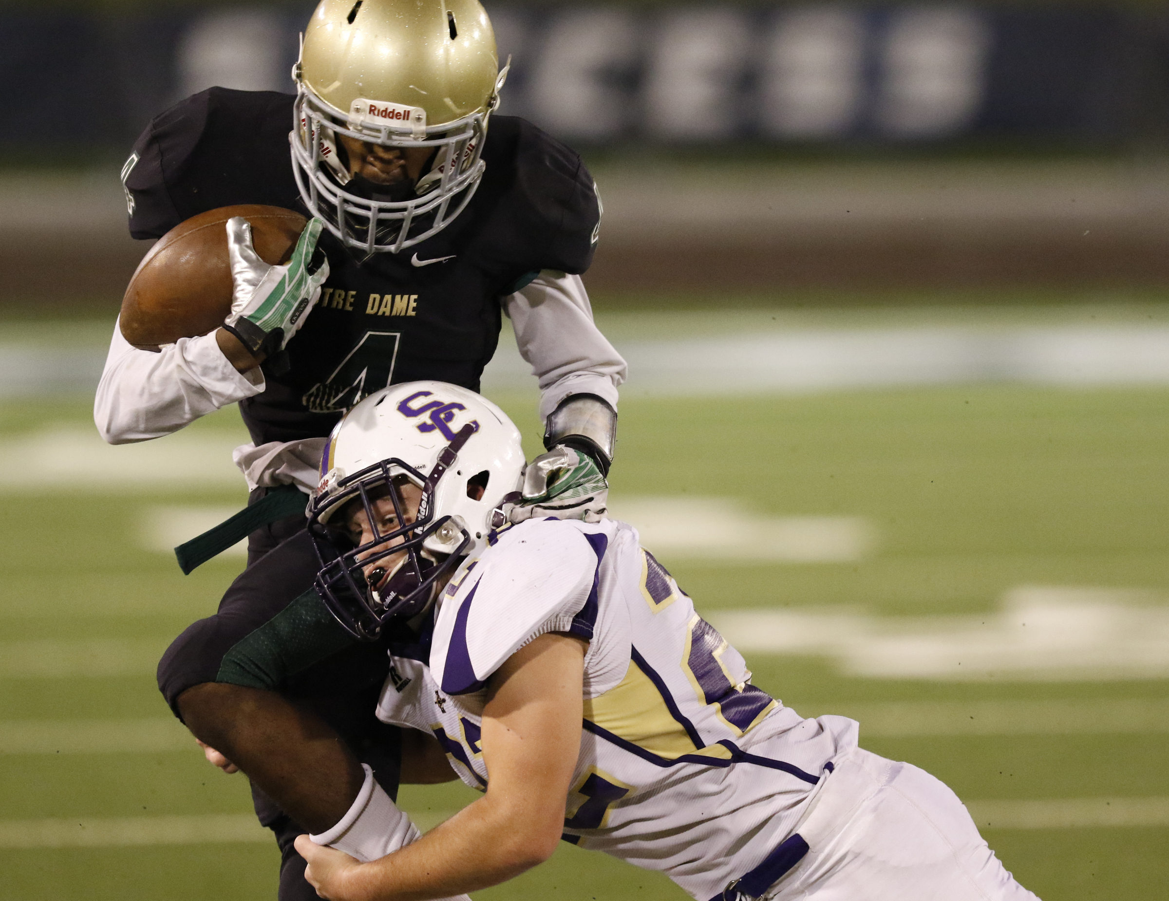 Staff Photo by Dan Henry / The Chattanooga Times Free Press- 11/6/15. Notre Dame High School's Calbin Sims (4) gets hit mid air trying to jump over Sequatchie County's Caleb Reed (22) during the first half of play at Finley Stadium in downtown Chattanooga on Friday.
