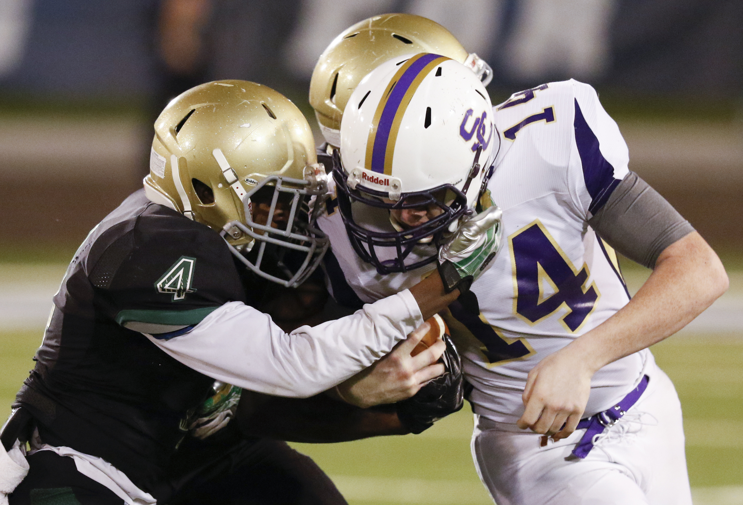 Staff Photo by Dan Henry / The Chattanooga Times Free Press- 11/6/15. Sequatchie County's Ethan Barker is facemasked by Notre Dame High School's Calvin Sims during the first half of play at Finley Stadium in downtown Chattanooga on Friday.