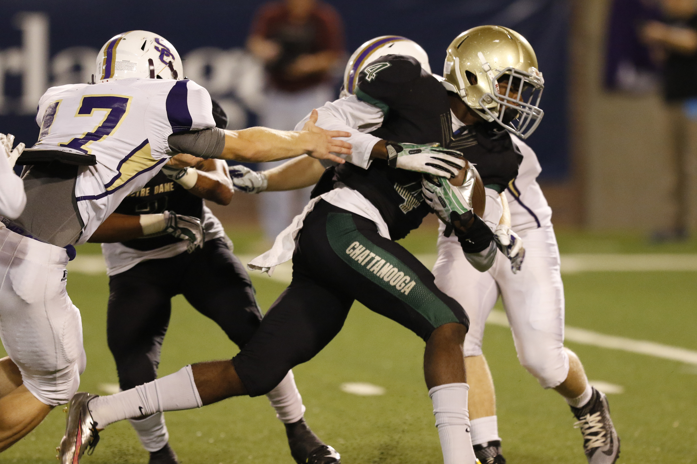 Notre Dame 's Calvin Sims tries to slip past Sequatchie County defenders during Friday night's Class 3A state playoff game at Finley Stadium.