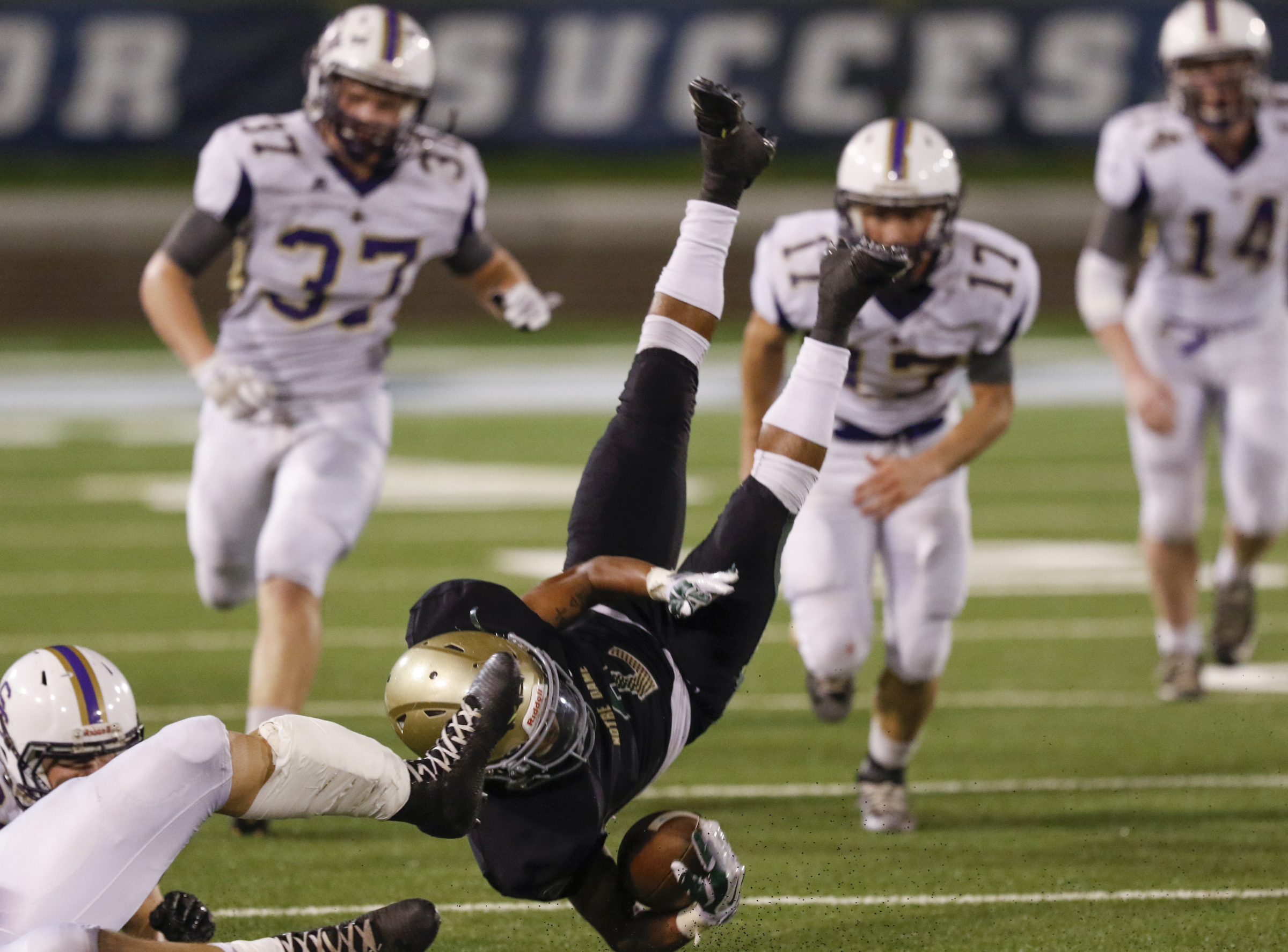 Staff Photo by Dan Henry / The Chattanooga Times Free Press- 11/6/15. Notre Dame High School's Andrew Banks (2) gets cartwheeled after being hit by Sequatchie County's Kyle Cates (2) during the first half of play at Finley Stadium in downtown Chattanooga on Friday.