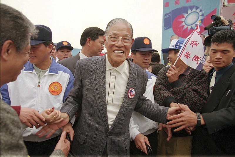 
              File - In this Mar. 24, 1996 file photo, re-elected President Lee Teng-hui, center, is congratulated by his supporters as he roams through some thousands of people gathered for a celebration rally in Taipei, Taiwan. China and Taiwan have been separately ruled since the Chinese civil war of the 1940s, but China claims sovereignty over the island and insists the two sides eventually unify. They have in recent years set aside that dispute to build trust and sign economic cooperation deals, and their presidents will meet for the first time Saturday, Nov. 7, 2015, in Singapore. (AP Photo/Vincent Yu)
            