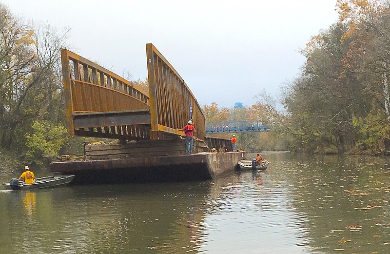 A barge pushed a new connector bridge for the South Chickamauga Greenway to the South Chickamauga Creek this morning. 